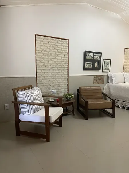 Apartamento Pica Pau, com poltronas e parede de tijolinho